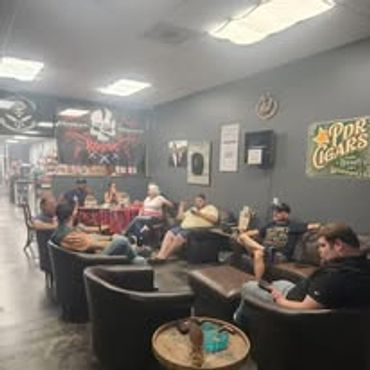 Group of people relaxing in a cozy cigar lounge.