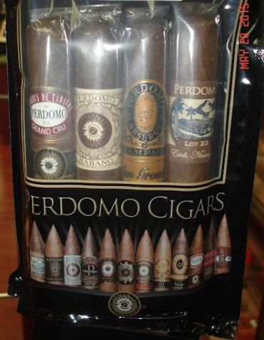 Pack of assorted Perdomo cigars with visible labels inside.