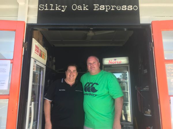Glen and Carmela standing in the doorway of Silky Oak Espresso.