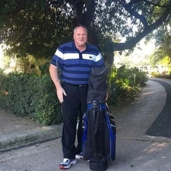 Glen standing alongside his golf bag.