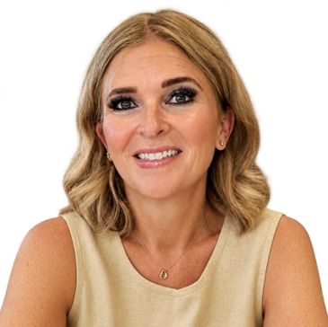 Smiling woman with blonde hair and beige sleeveless top.