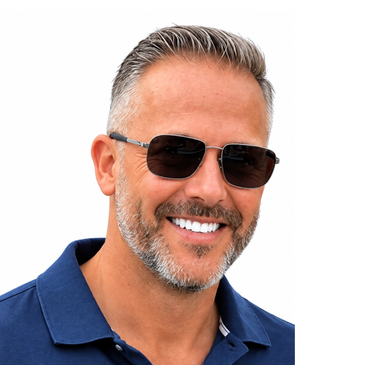 Smiling man wearing sunglasses and a blue polo shirt.