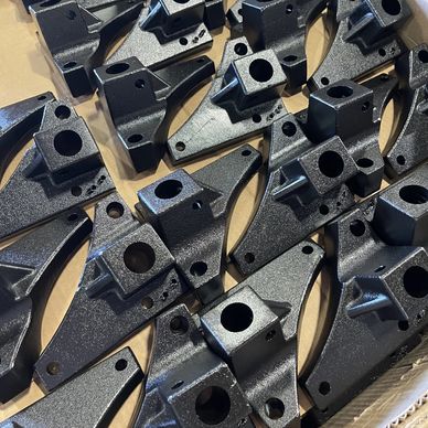 Black metal brackets with holes.