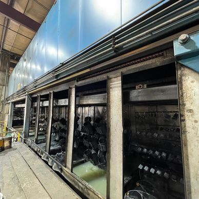 Industrial equipment with hanging parts inside.