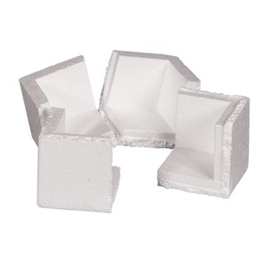 Four white foam corner protectors for packaging.