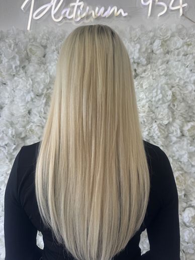 Platinum blonde hair with K-tip extensions back view