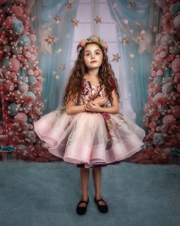 Painterly Portrait of Beautiful little girl in pink couture dress standing in front of window draped