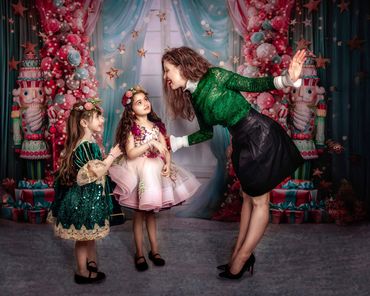 Painterly Portrait of Mama and Girls. In a Christmas room decked in big pink and blue Nutcrackers an