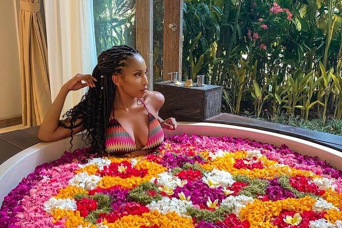 Woman relaxing in a flower-filled bathtub near a garden window.