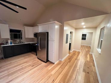 Renovated kitchen with two-tone cabinets and recessed lighting