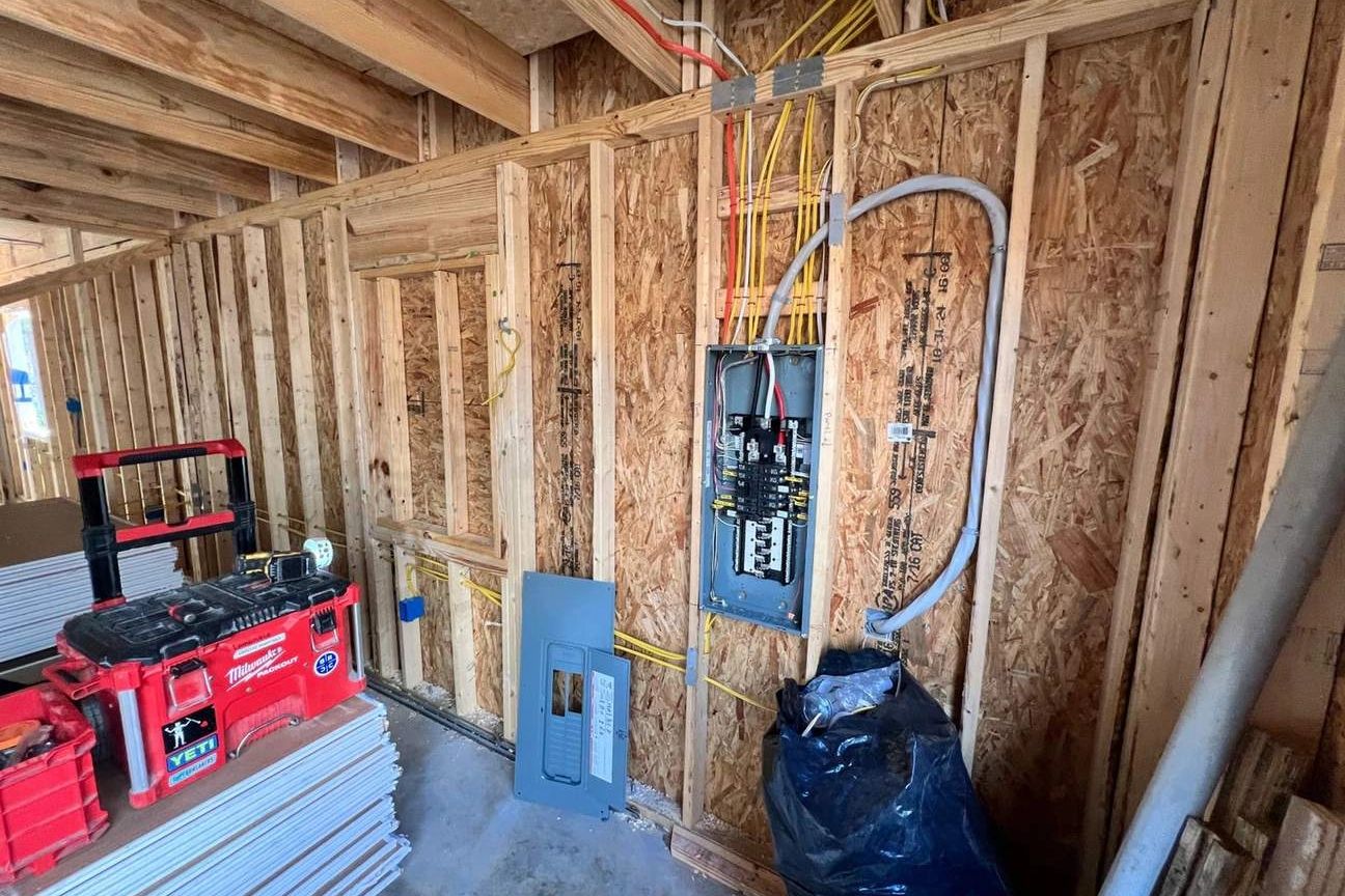 Electrical panel installation in a wood-framed building under construction
