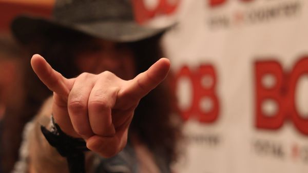 Person making a rock and roll hand sign.
