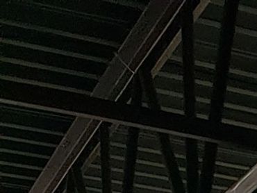 Interior of an unfinished room with construction equipment and large windows. lifworks cambridge ne