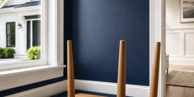 Wooden table turned upside down in a room with a blue wall.