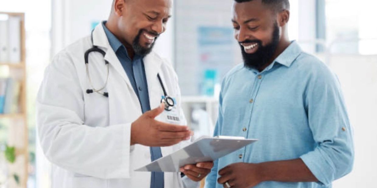 Doctor showing a clipboard to a happy patient.