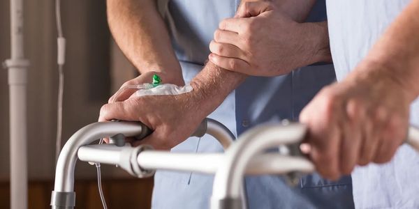 Carer helping an elder to move around