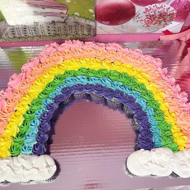 Rainbow cake with cloud decorations
