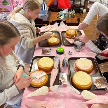 Children baking cupcakes together indoors