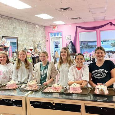 Kids decorating cupcakes at party