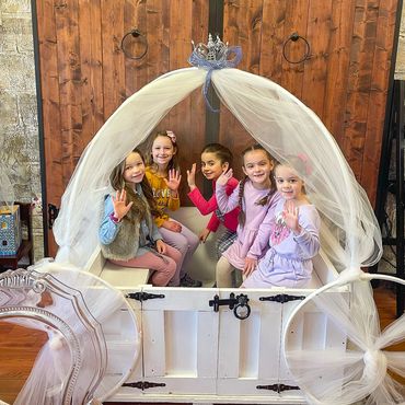 Children posing inside decorative shell