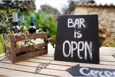 Bar open sign with bottles of wine