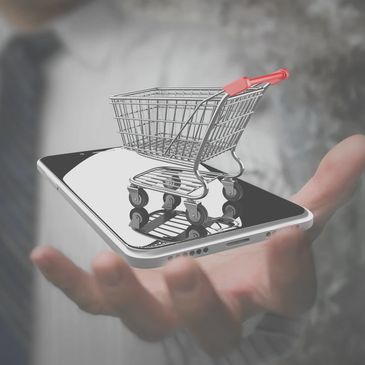 Mini shopping cart on a smartphone held by a person.