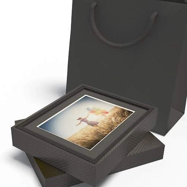 Elegant black gift box with a photo frame and matching black gift bag.