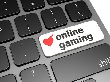 A computer keyboard with a sticker that says online gaming