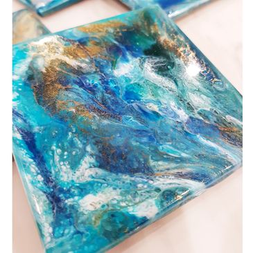 coaster set of 4. Hues of cobalts, gold and white.