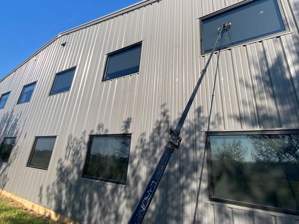 Window cleaning on a building's upper floor.