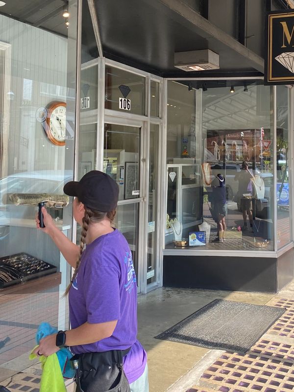 Person taking photo of jewelry store window.