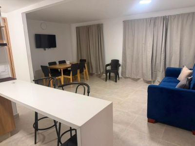 Modern dining and living area with a blue sofa and dining table