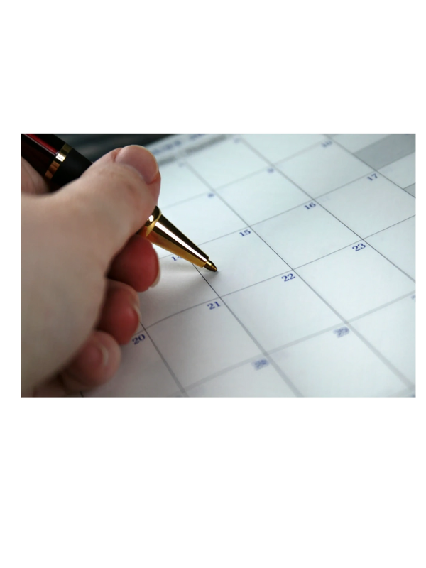 Person holding pen about to write on calendar