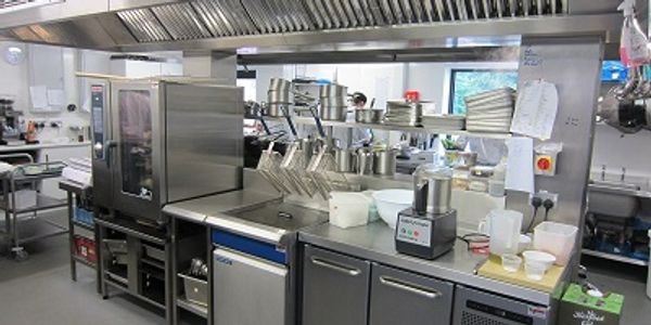 Commercial kitchen with stainless steel equipment belonging to an award winning restaurant in Wales