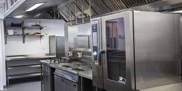 Rational combi oven within a school kitchen with bespoke extraction / ventilation systems above
