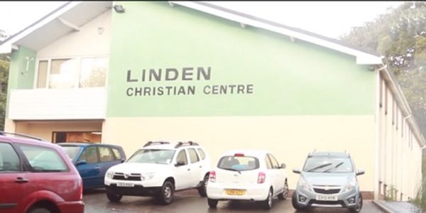 Outside car park and view of Linden Christian Centre building painted green and cream