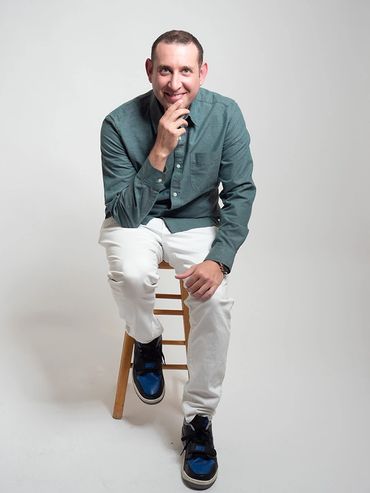 This comedian sitting a portrait that reflects his on-stage persona.