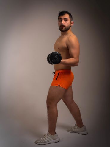 Fitness Portrait.  Body builder posing with weights.