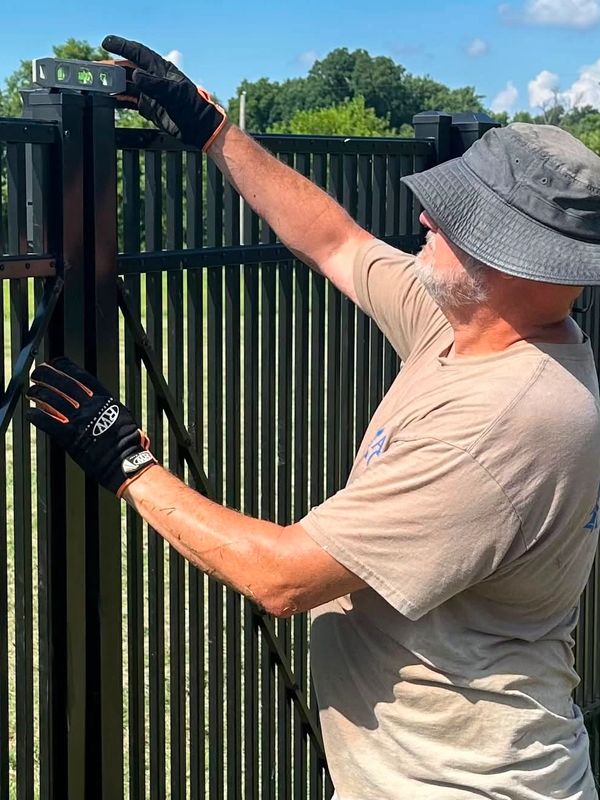Ronald Willis of Willis Outdoors LLC in Newburgh, Indiana adjusts an aluminum double gate.