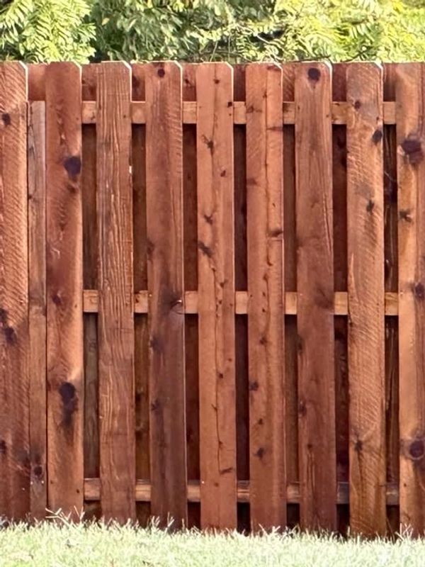 6’ tall cedar fence built & stained in a semi-transparent Pecan color by Willis Outdoors LLC