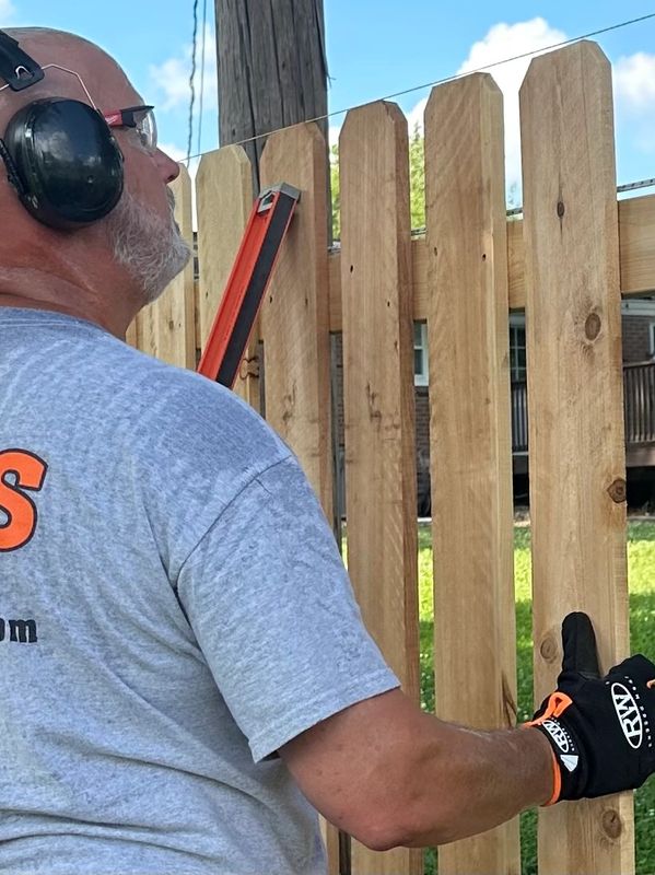 Ronald Willis building a wood fence in Newburgh, Indiana