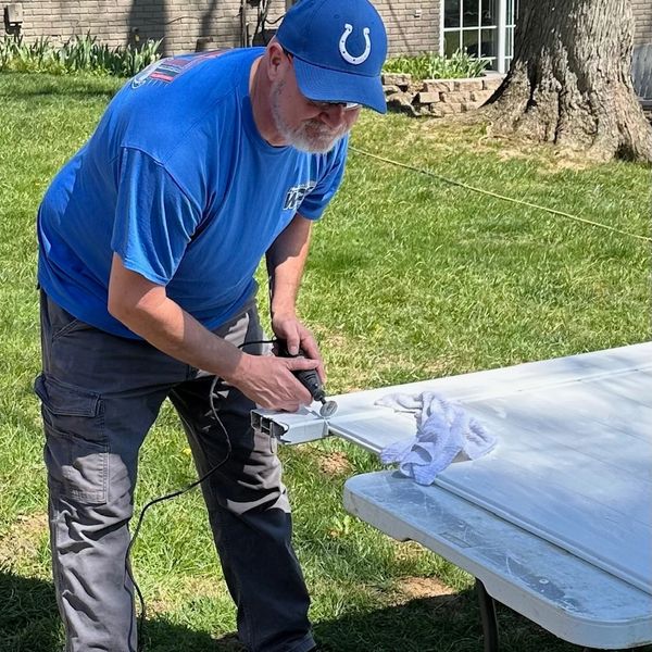 Fence Professional Ronald Willis repairing a polyvinyl gate in Newburgh, Indiana.