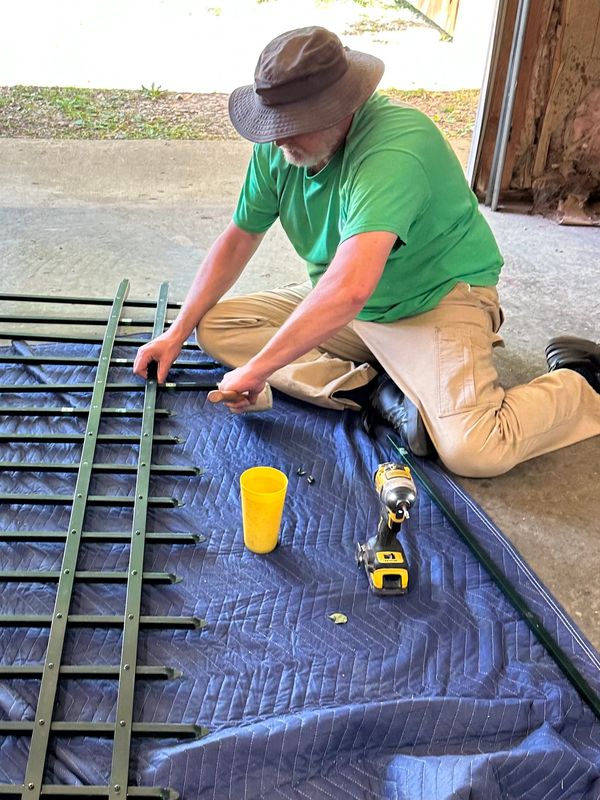 Fence professional Ronald Willis of Willis Outdoors LLC repairs a damaged fence