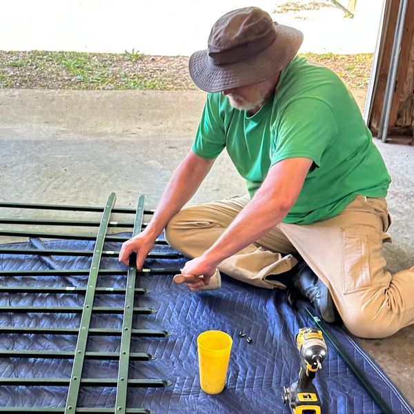 Fence professional Ronald Willis repairs a damaged fence panel for a project in Evansville, Indiana.