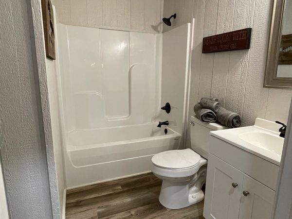 Tub/shower combo and 24" vanity make for plenty of room in this bathroom.