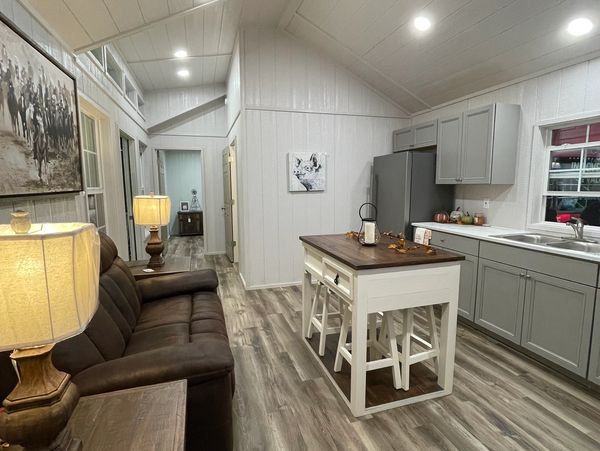 Vaulted ceilings & wafer lights give this a wide open feel. Gray cabinets and weathered wood vinyl.