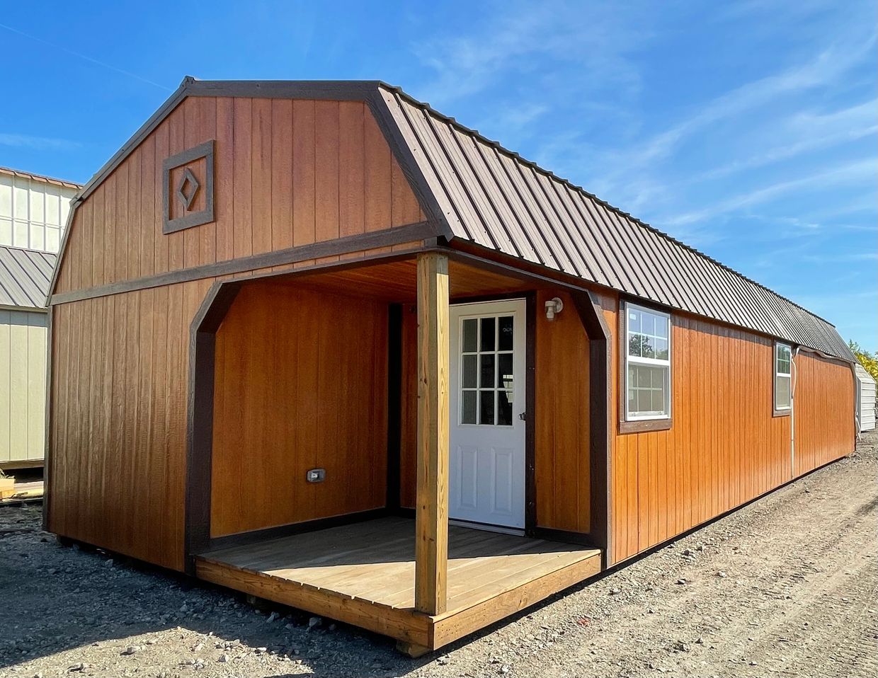 16x48 Lofted Barn in butternut & brown with a custom porch without railing and upgraded windows.