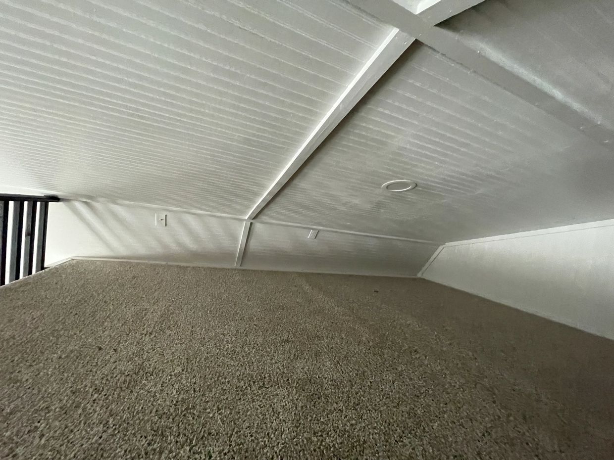 Lofts are finished with carpet, lights, black railing & ladders.