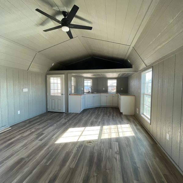 Light gray interior paint, white cabinets, custom counter top and weathered wood vinyl.