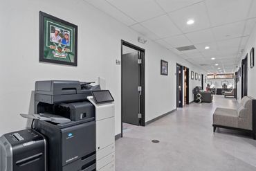 Black office chair beside modern work desk